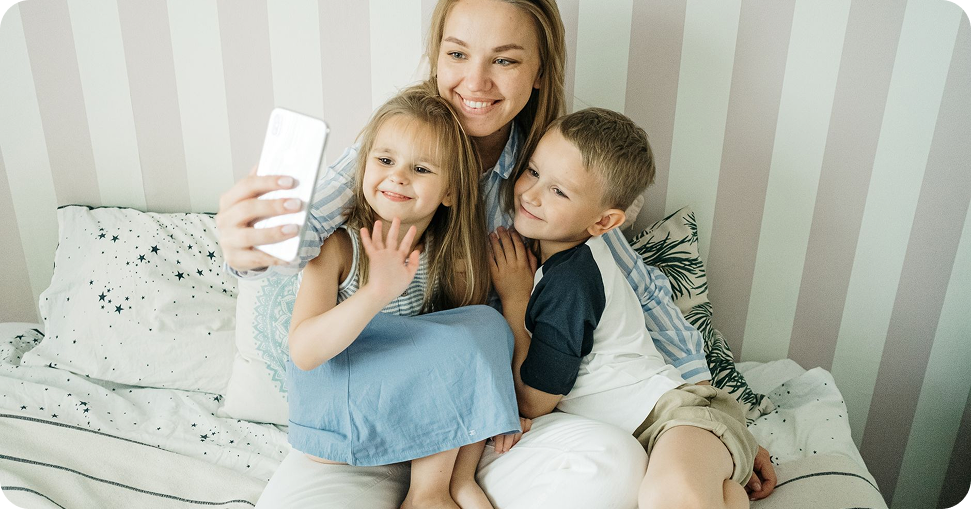 A parent and children recording a BabyMoments story together